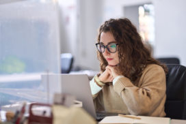 Young serious busy professional business woman employee or student using laptop watching online webinar or training web course, looking at computer, thinking, elearning, doing research concept.