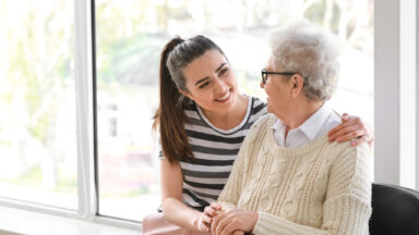 Young woman taking care of a senior woman