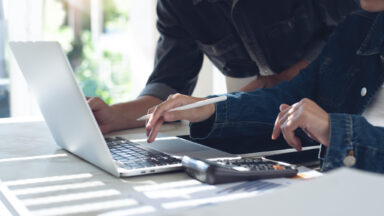 Close up of two asian startup colleagues working together