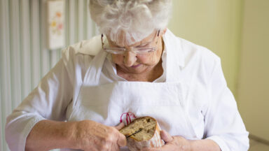 Eine Frau schneidet Brot mit einem Messer