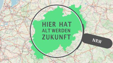 Eine Lupe über der Karte von NRW. In der Lupe steht 