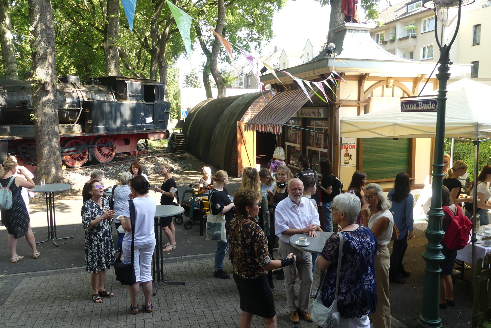 Kaffeepause im Hof des heimatmuseums Unser Fritz, im Hintergrund eine alte Trinkhalle sowie eine Dampflok